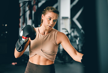 Image showing Fitness, sports and boxing with woman in gym for training, workout and mma challenge. Performance, energy and power with girl boxer and focus for fight, wellness and exercise in martial arts class