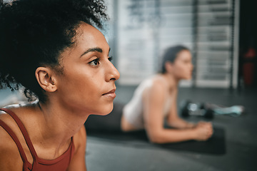 Image showing Black woman, gym focus and plank exercise of a person on the floor busy with workout and wellness. Sports, ground training and strength performance challenge of girl friends at a fitness health club