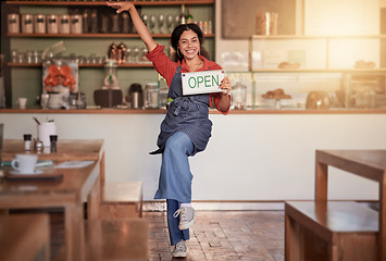 Image showing Cafe, woman and open sign in small business, startup and excited while celebrating success with dance. Black woman, coffee shop and business owner hold message, placard or advertising welcome board