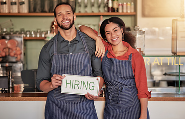 Image showing Small business, portrait or couple with a hiring sign for job vacancy offer at a cafe or coffee shop. Recruitment, marketing or happy entrepreneurs smile standing with an onboarding message in store