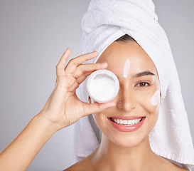 Image showing Woman, skincare cream and studio portrait for wellness, health or cosmetic benefits with towel by background. Young healthy model, lotion and skin glow for facial, self care or dermatology for beauty