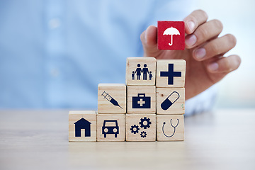 Image showing Insurance, wood building blocks and sign with hand for home, healthcare and car on desk for security. Icon toys, finance and protection for home, medicine and health for investment in safety service