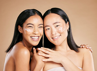 Image showing Portrait, cream and diversity with model woman friends in studio on a beige background for skincare. Face, natural and wellness with a young female and friend posing to promote a cosmetic product