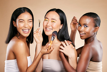 Image showing Diversity, smile and woman with makeup tools products for facial skincare, cosmetics dermatology and skin wellness. Interracial models, happy face portrait and luxury product satisfaction in studio