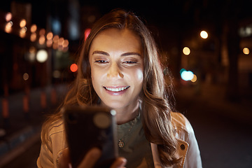 Image showing Student, face or phone in city night, road or street on social media, taxi call or cab search in Dubai location. Smile, happy woman or tourist person on mobile communication technology in dark travel