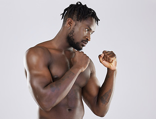 Image showing Muscular, fight and black man with focus, training and determination with guy against grey studio background. Muscles, African American male fighter or athlete practice, power or endurance for energy