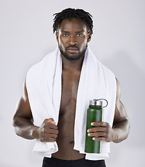 Image showing Black man, exercise and portrait with towel and water bottle for sports training in studio. Health and wellness of a sexy male bodybuilder model with ready for fitness workout, goals and strong body