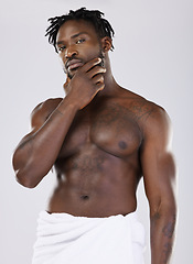 Image showing Skin, black man in towel and muscle in portrait, shower with hygiene and beauty isolated on studio background. Abs, fitness and facial wellness, skincare glow and body care with natural cosmetics