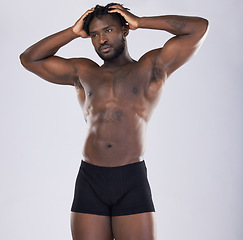 Image showing Sports person, fitness and body of black man in studio for strong muscle and power. Health and wellness of a sexy male bodybuilder model in underwear with growth after exercise, workout and training