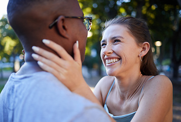 Image showing Love, happy or couple of friends in a park bonding on a romantic date in nature in an interracial relationship. Embrace, funny black man and young woman enjoying quality time on a holiday vacation