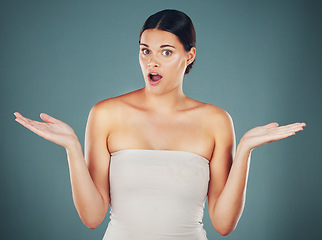 Image showing Woman, shocked face portrait and hands for surprise, announcement or excited isolated in studio background. Young female, scared facial expression and shock mouth with wow amazed hands gesture