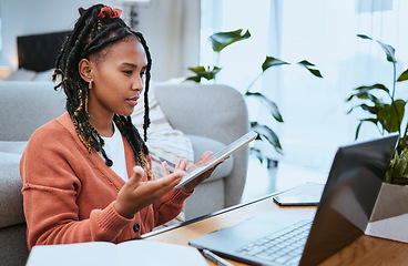 Image showing Black woman, laptop or student with tablet for education in living room for elearning, research or planning college scholarship. Confused girl on video call for internet, university or website search