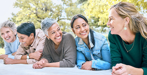 Image showing Happy, women and relax at a park, laughing and bonding while lying on a blanket together. Diversity, friends and woman group bonding, funny and enjoying comic, humor and goofy joke while on a picnic