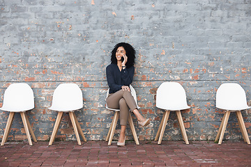 Image showing Phone call, recruitment and black woman on brick wall, sitting in line for hr news, job opportunity and success. Smartphone, waiting room and person mobile chat for career networking and contact us