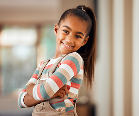 Image showing Happy, smile and portrait of a girl child in her home with a positive mindset standing with crossed arms. Happiness. beautiful and young kid with a casual, stylish and trendy outfit posing in house.