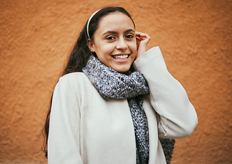 Image showing Happy woman, portrait or hair tuck behind ear by city wall, mockup background or brown mock up in Portugal. Smile, fashion or model in trendy, cool or warm style clothes on building copyspace brand