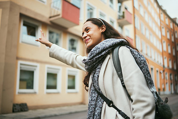 Image showing Happy woman, travel and hailing taxi in city, street and road in transportation, traveling and urban commute. Smile, tourist and fashion student stopping cab, lift or sightseeing bus in town location