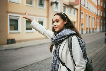 Image showing Woman, travel or hailing taxi in city, street or New York road in transportation, traveling or urban commute. Tourist, student or person waiting for cab, lift stop or sightseeing bus in town location