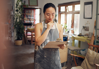 Image showing Woman, thinking or clipboard in pottery studio, ceramic small business or Asian art workshop on class schedule. Mud, craft or designer worker with clay vision, ideas or innovation on paper documents