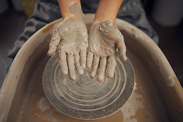 Image showing Hands, clay and pottery wheel in a workshop after creating a sculpture or project for a small business. Creative, crafts and artistic sculptor manufacturing handicraft mould products in an art studio