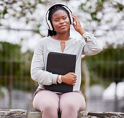 Image showing Headphones, black woman and outdoor for peace, happiness and audio with young student calm in park. African American female, lady or girl with folder, headset for podcast or streaming music in nature