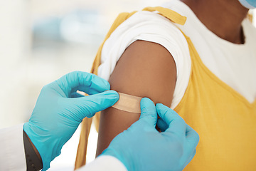 Image showing Covid, vaccine and bandaid on the arm of a black woman patient in a hospital for an injection or healthcare. Doctor, medical and insurance with a female in a clinc for her corona virus vaccination