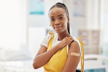 Image showing Portrait, covid or vaccine and a black woman with a plaster on arm sitting in a hospital. Medical, insurance or healthcare and a female in a clinic with a bandaid on shoulder for corona vaccination