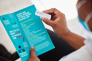 Image showing Black man, hands and covid test with brochure for information, insurance or sample at hospital. Hand of African American patient holding rapid test or pamphlet for healthcare instruction or diagnosis