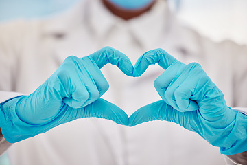 Image showing Healthcare, heart or hands and a doctor in a hospital with gloves making a gesture or hand sign for health. Medical, insurance and love with a medicine professional gesturing an emoji, symbol or icon