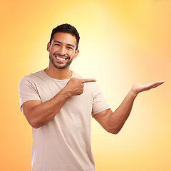 Image showing Portrait, pointing and man with product placement in studio isolated on yellow background. Mockup, branding and happy male with gesture for copy space, mock up or advertising, marketing or promotion