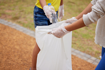 Image showing Charity, earth day and volunteer cleaning trash for climate change outdoors at park to recycle for the environment. Planet, sustainability and community activists to pickup pollution, trash or litter