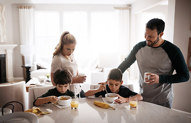 Image showing Family home, boy children and breakfast with mom, dad and healthy start to morning for balance diet. Mother, father and kids at table with fruit, food or happy for bonding, love or nutrition wellness