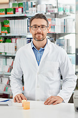 Image showing Pharmacy, portrait and pharmacist man with pills bottle, medicine or product in retail or healthcare industry. Trust, help desk and medical professional worker with supplements stock or clinic drugs