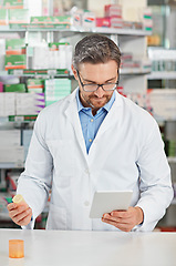 Image showing Pharmacist man, store and reading with tablet, focus and medicine for marketing, pills or sales. Medical professional, pharma expert and mobile digital tech in pharmacy for wellness, health and care