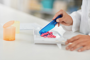 Image showing Hands, pharmacist and counting pills for drug dose, packaging or prescription at a pharmacy. Hand of doctor working with medication tablets or pharmaceutical drugs for healthcare on counter at clinic