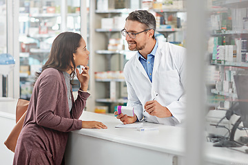 Image showing Pharmacist, customer and health with medicine and advice, discussion and service in pharmacy, advice and pills prescription. Healthcare, medical store with pharmaceutical drugs, man and woman talk