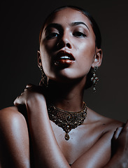 Image showing Beauty, jewellery and portrait of a woman in a studio with elegant, fancy and stylish accessories. Cosmetic, style and female model from Mexico with beautiful jewelry posing by a black background.