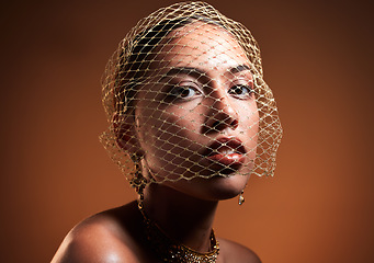 Image showing Stylish, elegant and portrait of a model with a net veil isolated on a brown background in studio. Fashion, vintage and face of a young retro model with a fashionable facial accessory on a backdrop