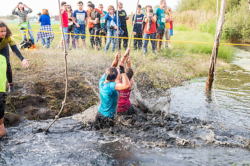 Image showing Athletes go through mud and water