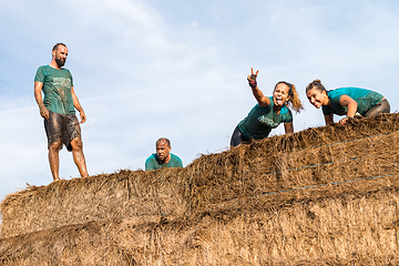 Image showing Athletes overcoming the hay osbtacle