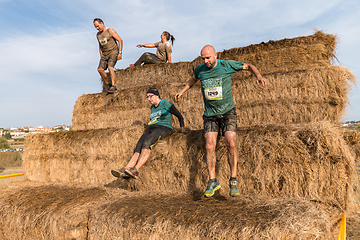 Image showing Athletes overcoming the hay osbtacle