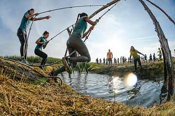 Image showing Athletes go through mud and water