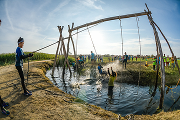 Image showing Athletes go through mud and water