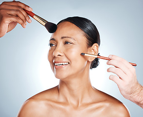 Image showing Woman, hands and smile for beauty makeup, cosmetics or facial treatment against a grey studio background. Happy female model smiling in satisfaction for skincare, pamper and brushes on her face