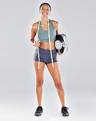 Image showing Portrait, black woman and scale for fitness, healthy lifestyle and diet with girl on grey studio background. Jamaican female, lady and athlete with measuring tape, smile and confident with wellness