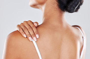 Image showing Shoulder pain, injury and woman hand on her back due to hurt, inflammation or muscle strain isolated in a studio gray background. Stress, spa and massage by model for body health or wellness