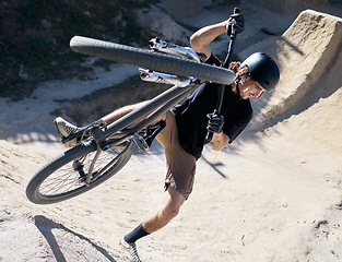 Image showing Man, bike and sport trick in the dunes for fitness, parkour or cycling workout in nature outdoors. Male cyclist or biker in sports training, exercise or competition on safari dirt track with bicycle