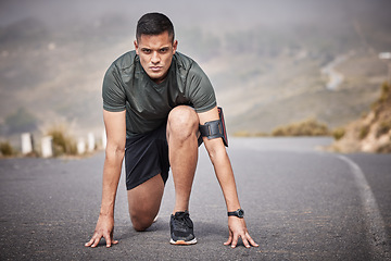 Image showing Runner, start and man race in road for cardio exercise, workout and urban fitness on mountains. Sports person, athlete and guy ready to begin running in street, sprint and focus on marathon training