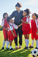 Image showing Soccer, girl group hug and coach with happiness, smile or team building, diversity and solidarity on grass pitch. Young female kids, football coaching or love for mentor woman on field for motivation