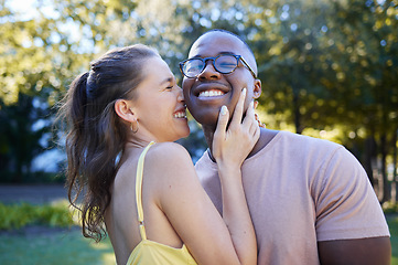 Image showing Summer, love and laugh with an interracial couple bonding outdoor together in a park or garden. Nature, diversity and romance with a man and woman hugging while on a date outside in the countryside